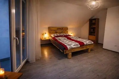 a bedroom with a bed in a room with a window at Pod Łopieniem z Sauną i Balią in Tymbark