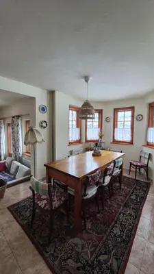 a dining room with a wooden table and chairs at Dom na Leśnej - Mszana Dolna in Mszana Dolna