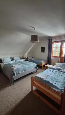a bedroom with two beds and a large window at Dom na Leśnej - Mszana Dolna in Mszana Dolna