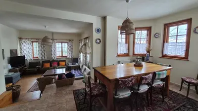 a living room with a wooden table and a living room at Dom na Leśnej - Mszana Dolna in Mszana Dolna