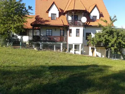 a large house with an orange roof on a hill at Dom na Leśnej - Mszana Dolna in Mszana Dolna