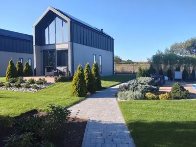 a large building with a walkway in front of it at Green Garden Zielonki 14e in Bibice