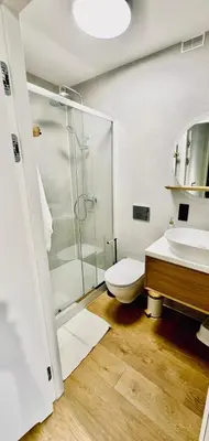 a bathroom with a shower and a toilet and a sink at Green Garden Zielonki 14e in Bibice