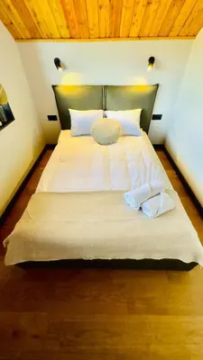 a bedroom with a large bed with two towels on it at Green Garden Zielonki 14e in Bibice