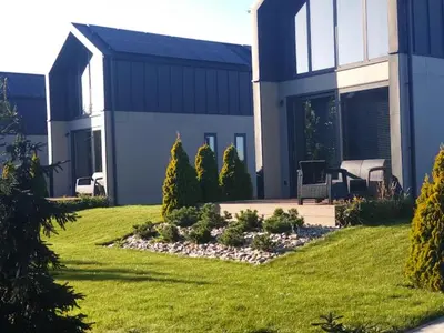a large house with a garden in front of it at Green Garden Zielonki 14e in Bibice