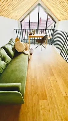 a living room with a green couch and a table at Green Garden Zielonki 14d in Bibice