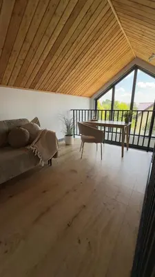 a living room with a couch and a table at Green Garden Zielonki 14d in Bibice