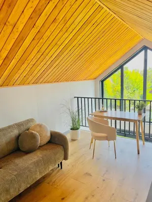 a living room with a couch and a table at Green Garden Zielonki 14d in Bibice