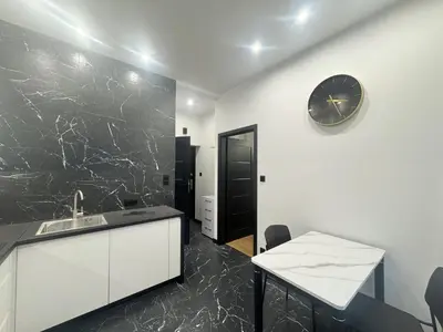 a kitchen with a sink and a clock on the wall at Pawlikowskiego nest - 5 minutes walk to Main Square in Kraków