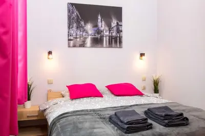 a bedroom with a bed with two pink pillows at Wawel Castle in Kraków