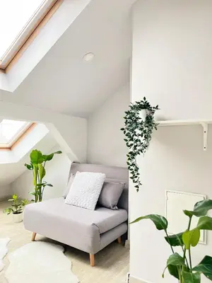 a living room with a couch and plants at Spacious Apartment with 5 bedrooms and 2 bathrooms for 12 guest in Cracow Old Town in Kraków