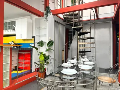 a dining room with a glass table and a spiral staircase at Spacious Apartment with 5 bedrooms and 2 bathrooms for 12 guest in Cracow Old Town in Kraków
