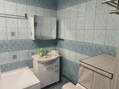 a bathroom with a sink and a toilet at CityLink Studio - Free Public Parking in Kraków