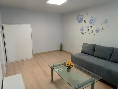 a living room with a couch and a glass table at CityLink Studio - Free Public Parking in Kraków