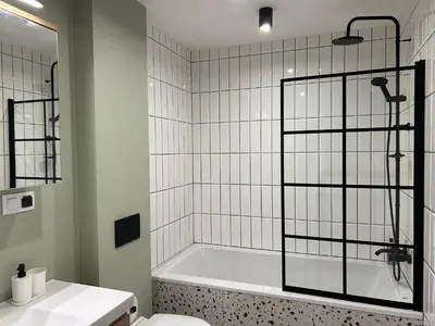 a bathroom with a tub and a toilet and a shower at Apartament lawendowy in Kraków