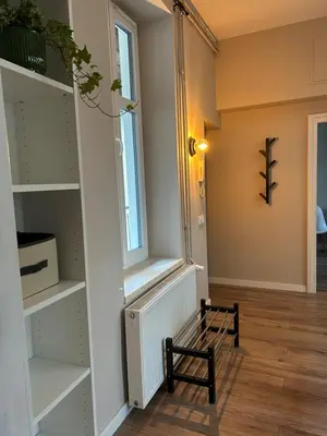 an empty hallway with a staircase and a tile floor at Apartament lawendowy in Kraków