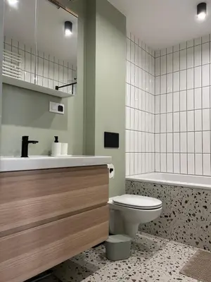 a bathroom with a toilet and a sink and a tub at Apartament lawendowy in Kraków