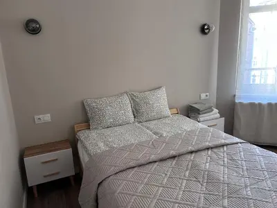 a bedroom with a bed and a window at Apartament lawendowy in Kraków