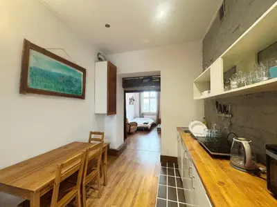 a kitchen with a wooden table and a counter top at Vintage Dajwor - in the center of Kazimierz in Kraków