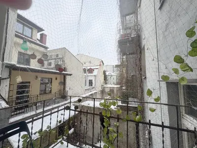 a view of a balcony with snow on the ground at Vintage Dajwor - in the center of Kazimierz in Kraków