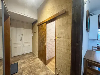 a room with a door to a room with a kitchen at Vintage Dajwor - in the center of Kazimierz in Kraków