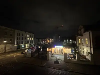 a city at night with lights on a street at Vintage Dajwor - in the center of Kazimierz in Kraków