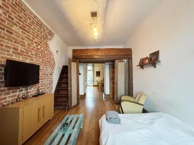 a room with a bed and a brick wall at Vintage Dajwor - in the center of Kazimierz in Kraków