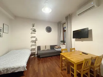 a bedroom with a bed and a table and a room at Paulinska paradise in Kraków