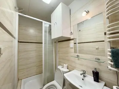 a bathroom with a toilet and a sink at Paulinska paradise in Kraków