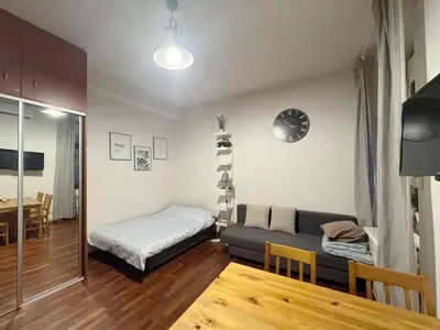 a living room with a bed and a couch at Paulinska paradise in Kraków
