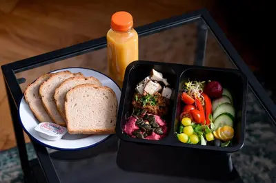 a lunch box with a sandwich and a plate of food at Native Apartments Sarego 16 in Kraków
