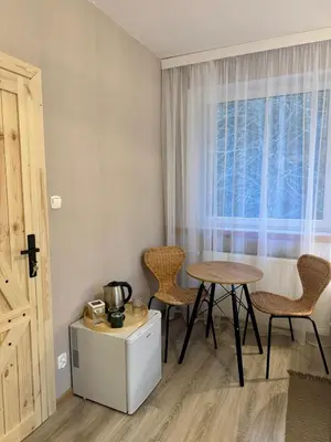 a room with a table and chairs and a window at Uroczysko pod Babią Górą in Zawoja