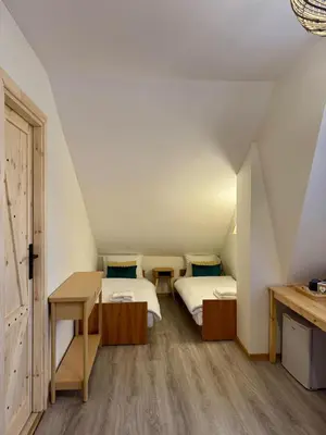 a small room with two beds and a desk at Uroczysko pod Babią Górą in Zawoja