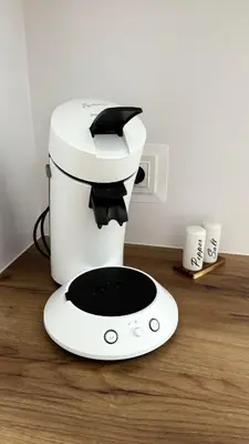 a coffee maker sitting on top of a wooden counter at Mickiewicz House Apartamenty in Wadowice