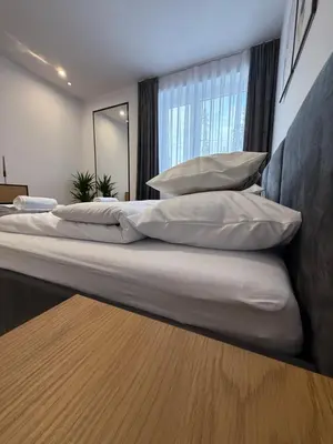 a large bed with pillows on it in a bedroom at Mickiewicz House Apartamenty in Wadowice