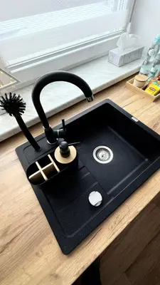 a black sink with a faucet on a kitchen counter at Mickiewicz House Apartamenty in Wadowice