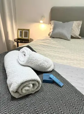 a bed with towels and a scale on it at Luxury Apartment with Garden Krakow in Kraków