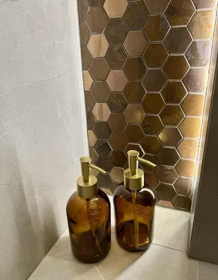 two bottles of soap sitting on the floor in a bathroom at Luxury Apartment with Garden Krakow in Kraków