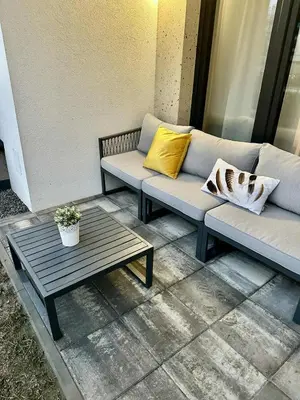 a couch and a coffee table on a patio at Luxury Apartment with Garden Krakow in Kraków