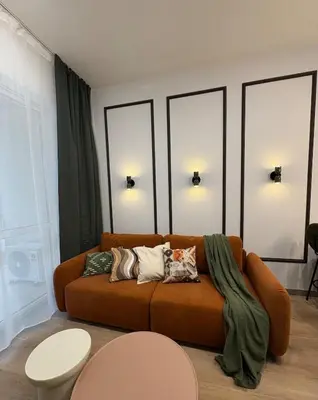 a living room with a couch with pillows on it at City Heaven Bonarka Kraków in Kraków