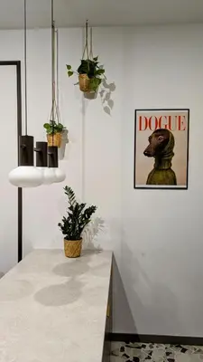 a kitchen with potted plants and a picture of a dog at City Heaven Bonarka Kraków in Kraków
