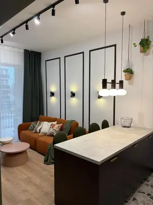 a living room with a couch and a table at City Heaven Bonarka Kraków in Kraków