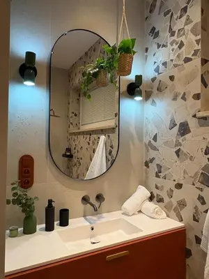 a bathroom with a sink and a mirror at City Heaven Bonarka Kraków in Kraków