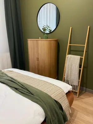 a bedroom with a bed and a round mirror at City Heaven Bonarka Kraków in Kraków