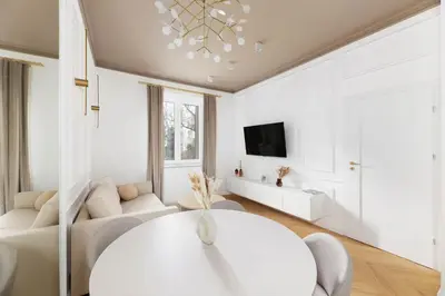 a white living room with a white couch and a table at Pawlikowskiego 12 by Homeprime in Kraków