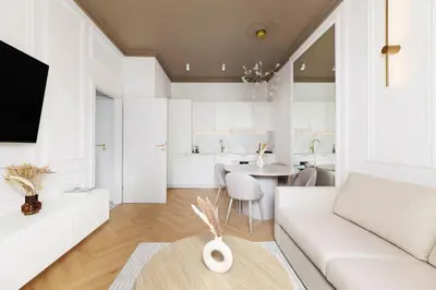 a white living room with a white couch and a table at Pawlikowskiego 12 by Homeprime in Kraków