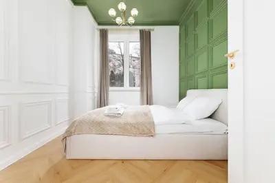 a bedroom with a white bed and a window at Pawlikowskiego 12 by Homeprime in Kraków