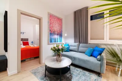 a living room with a couch and a table at Cozy & Modern Apartments, Old Town in Kraków