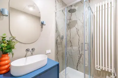 a bathroom with a sink and a shower at Cozy & Modern Apartments, Old Town in Kraków