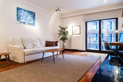 a kitchen and living room with a table and a couch at Househost Apartment Szlak 77 Angel City in Kraków